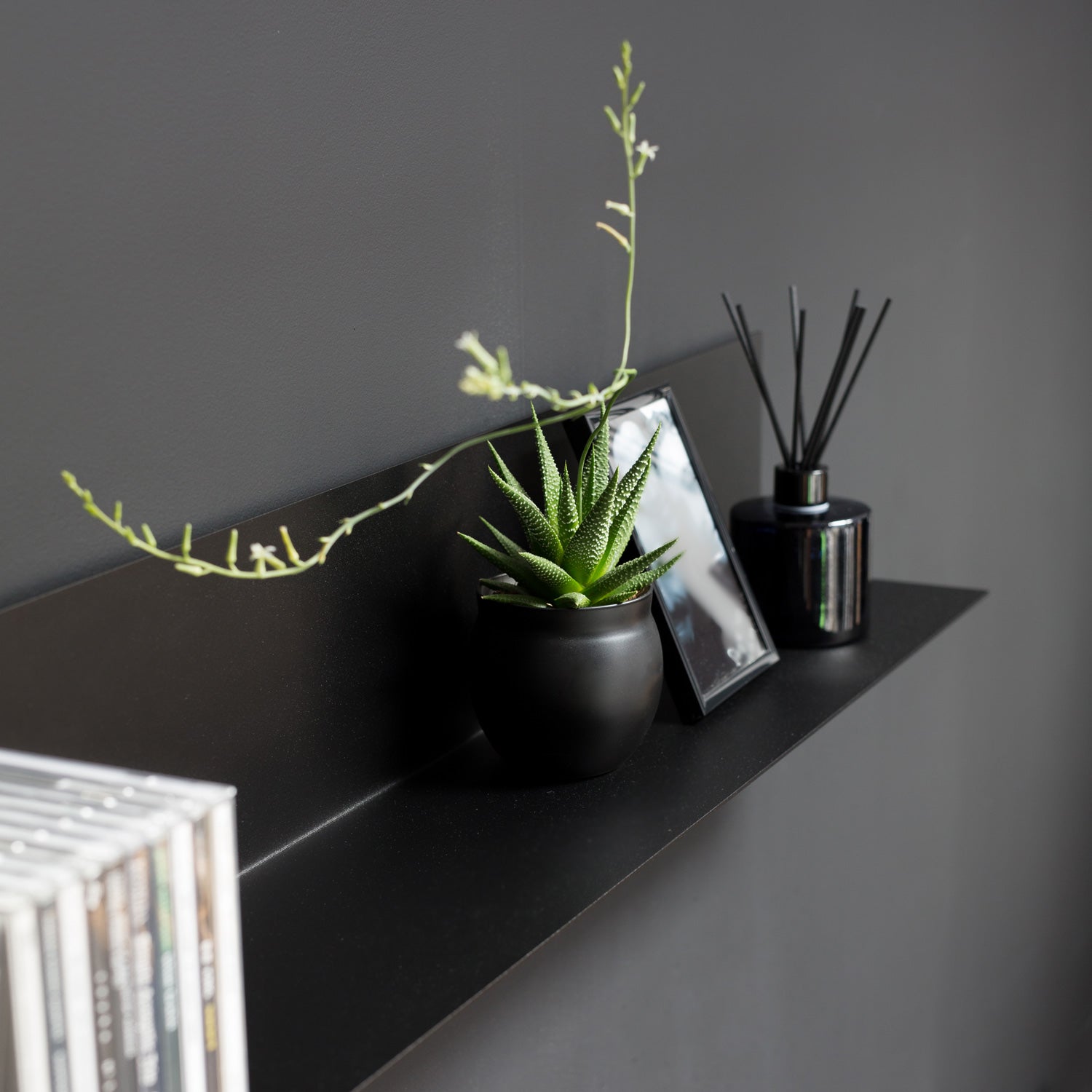 Black L shaped shelf detail view