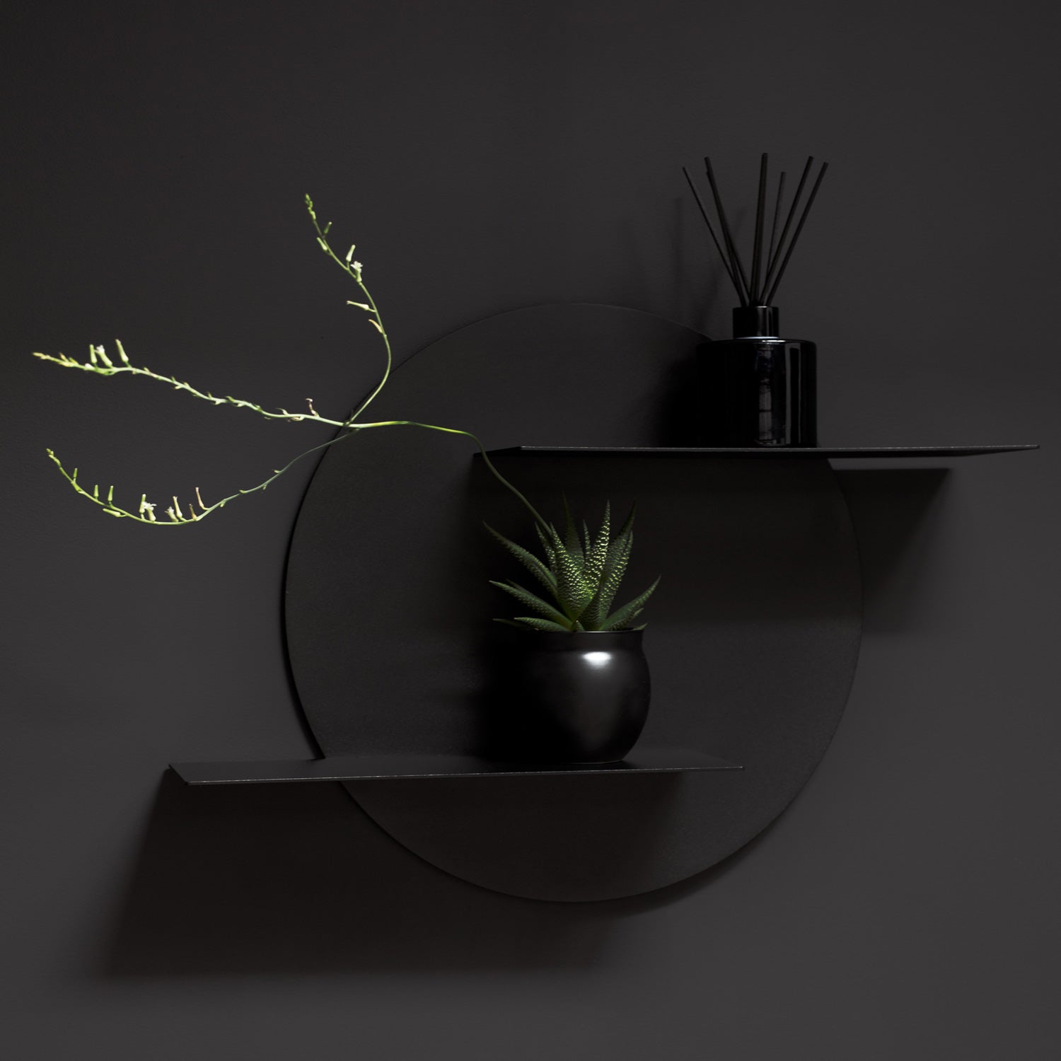 Black decorative wall shelf on black wall
