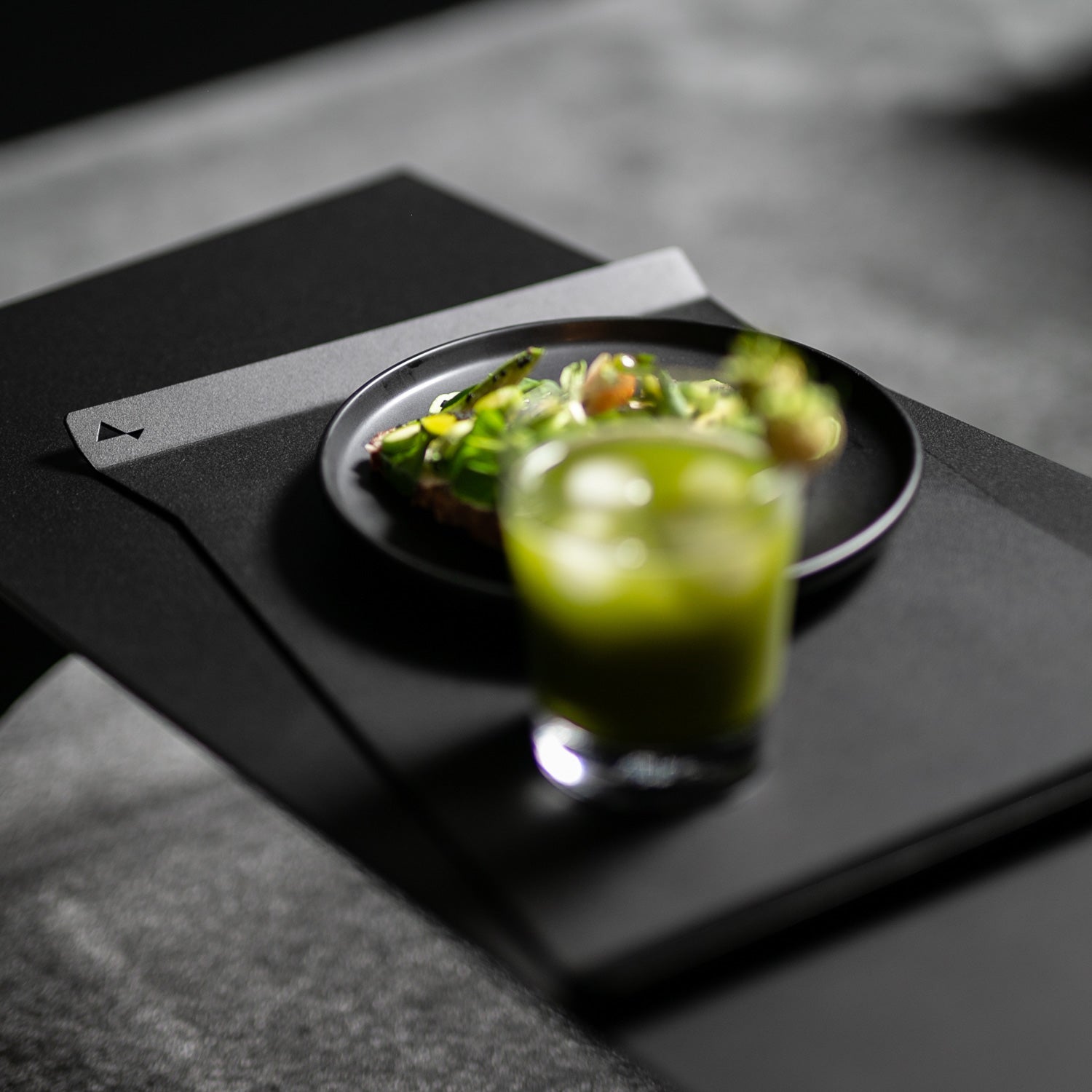 Minimalist black serving tray captured in close-up perspective