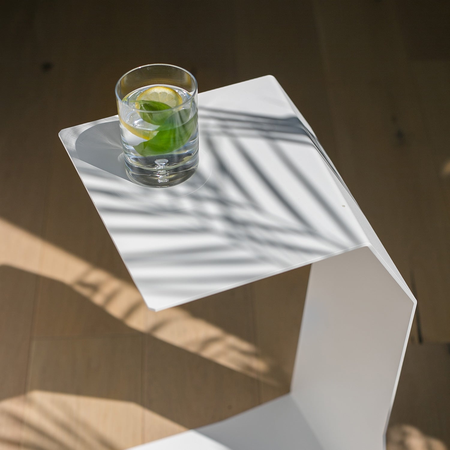 white designer end table on wooden floor