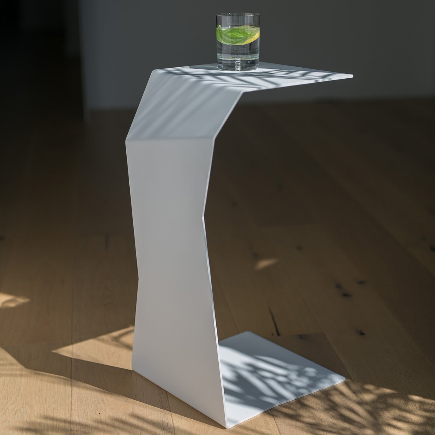 designer side table on wooden floor with glass on top