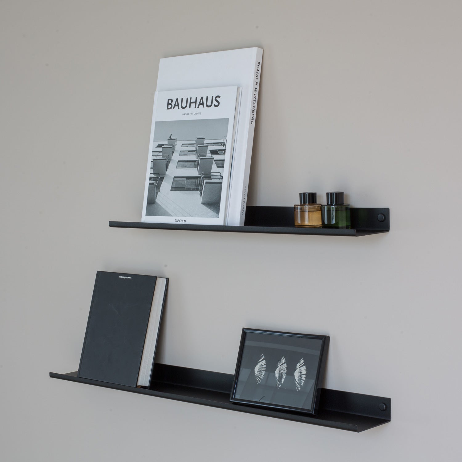 black narrow wall shelves with books