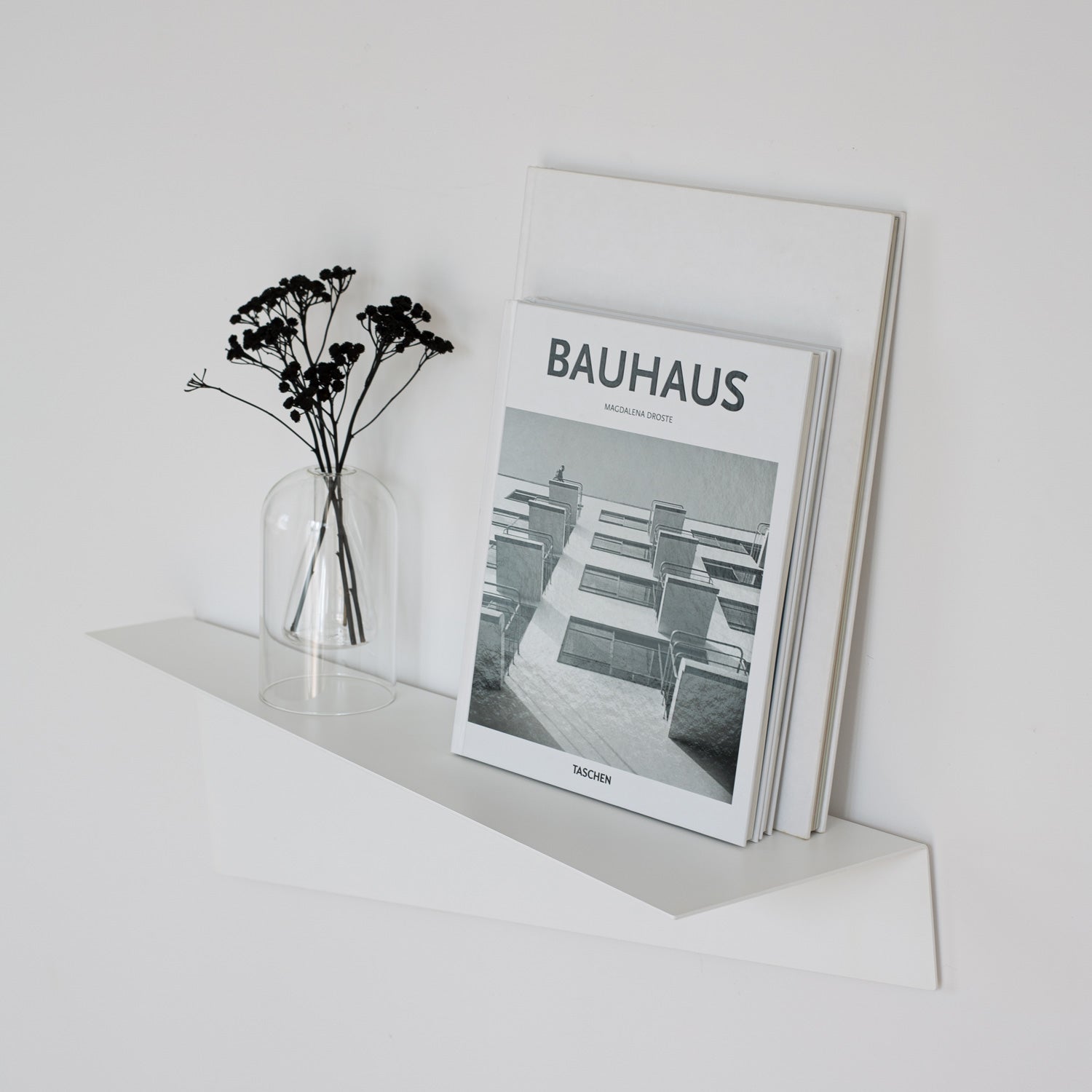 white modern decorative book shelf on white wall