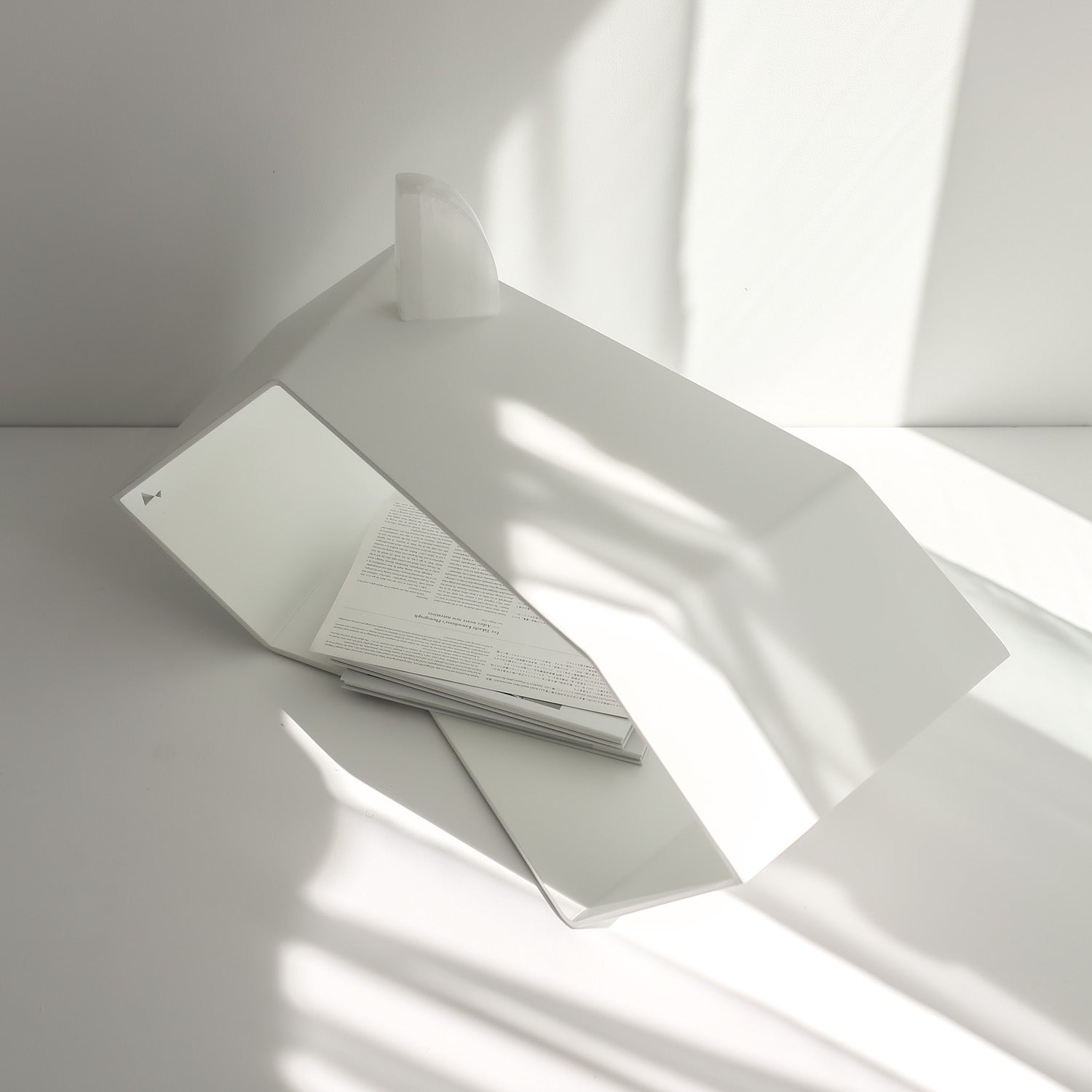 modern white coffee table with unique deisgn on white floor