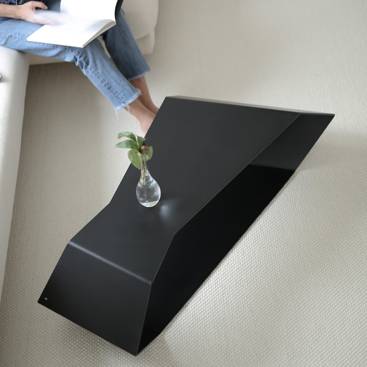 Black large coffee table in high quality finish on cream carpet in modern interior