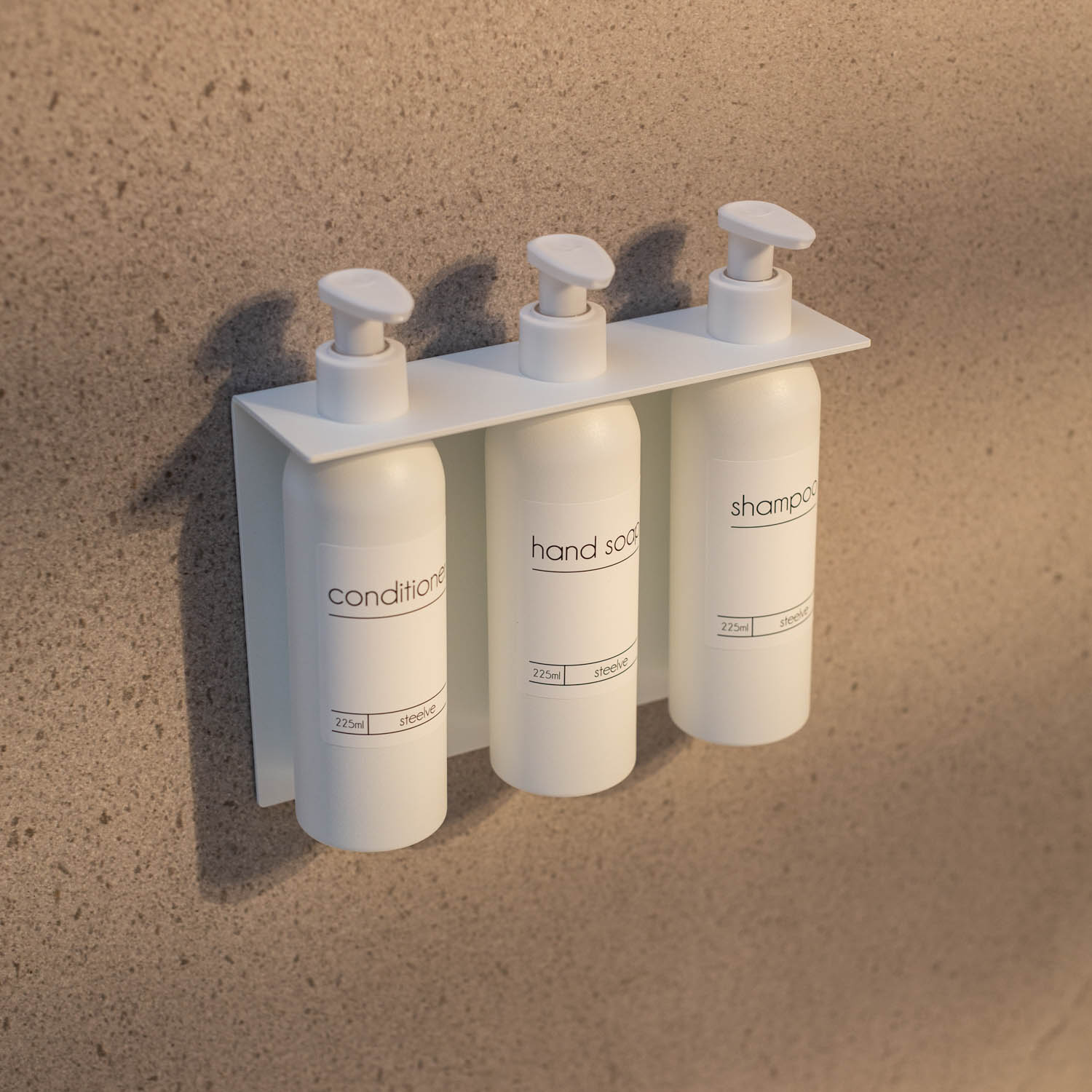 White wall pump bottle holder on beige tiles