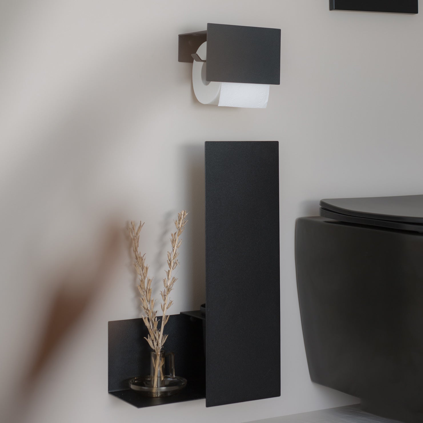 black toilet set on beige tiles 