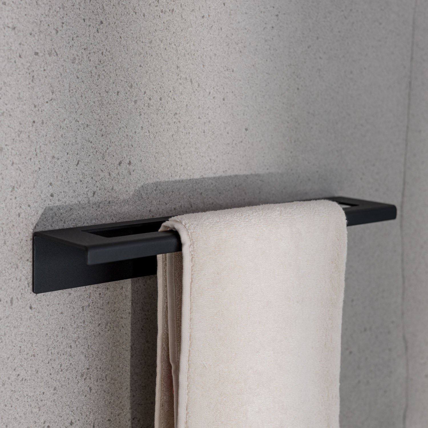 Drill free small Black towel rack with a white towel on a gray wall