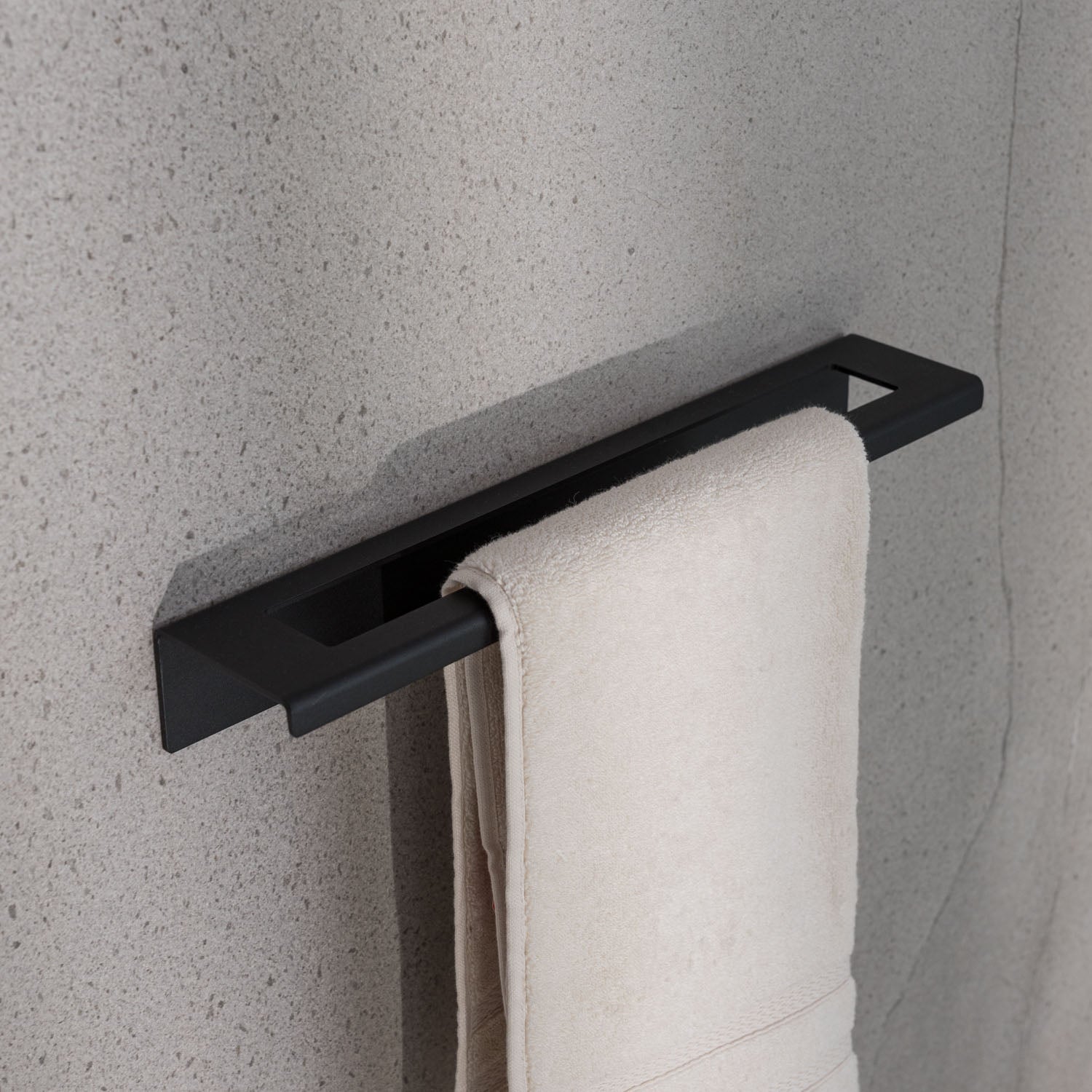 rent friendly Black towel rack with a white towel on a gray wall