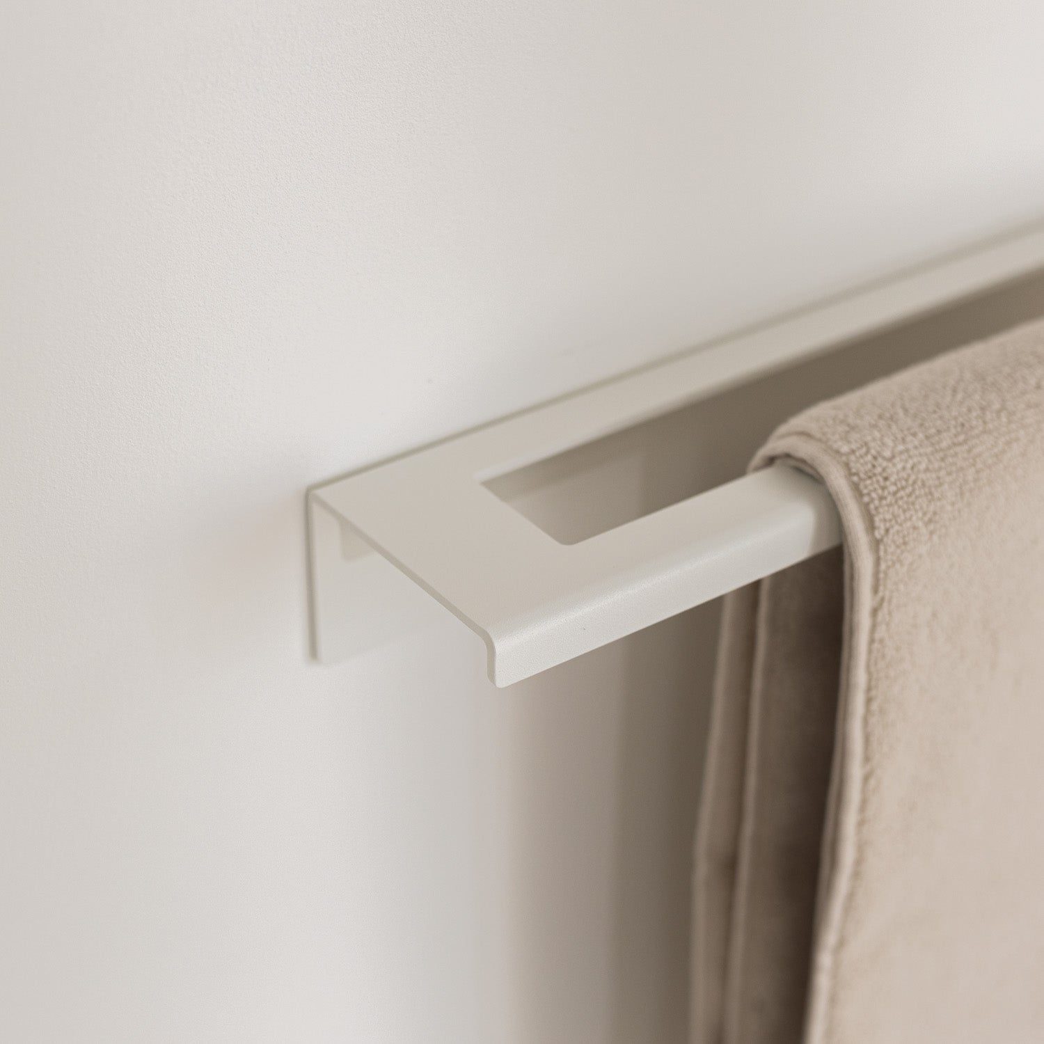 No-drill white towel rack with a towel in modern bathroom
